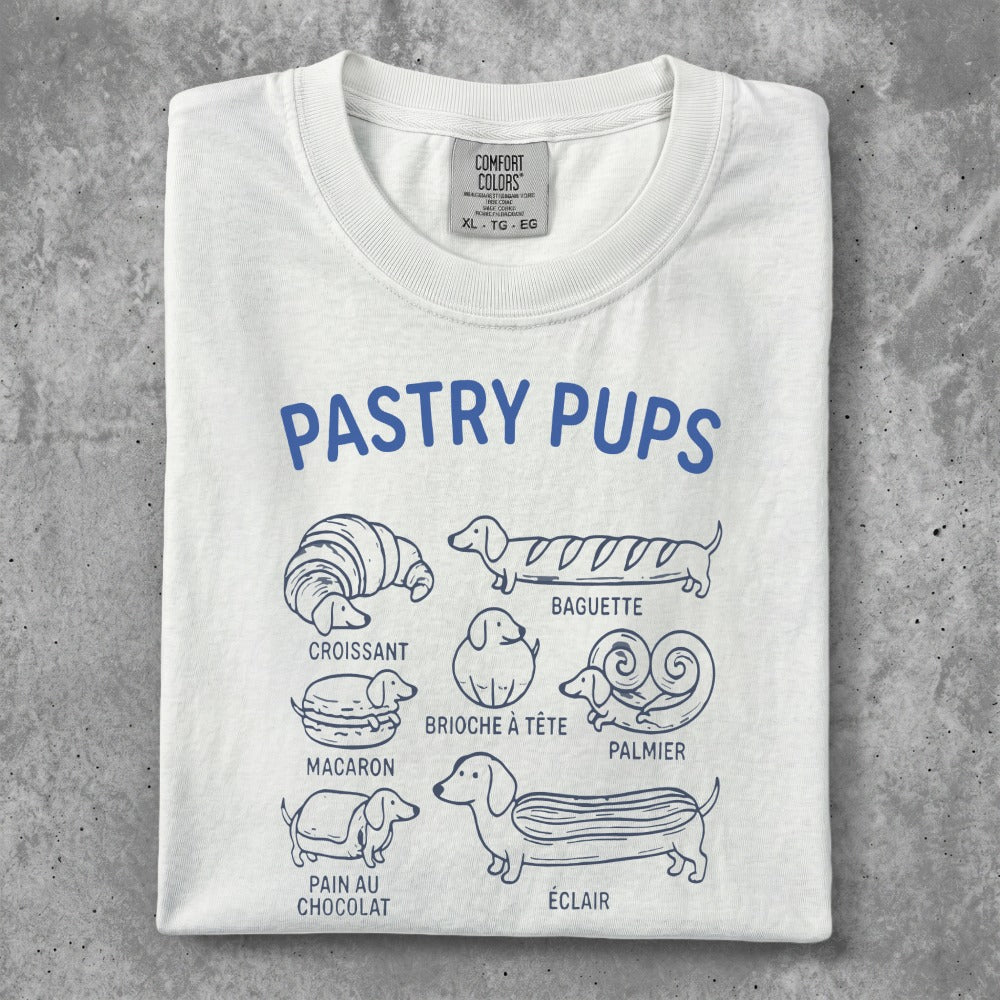 White t-shirt with "Pastry Pups" design featuring illustrated pastries and French names.