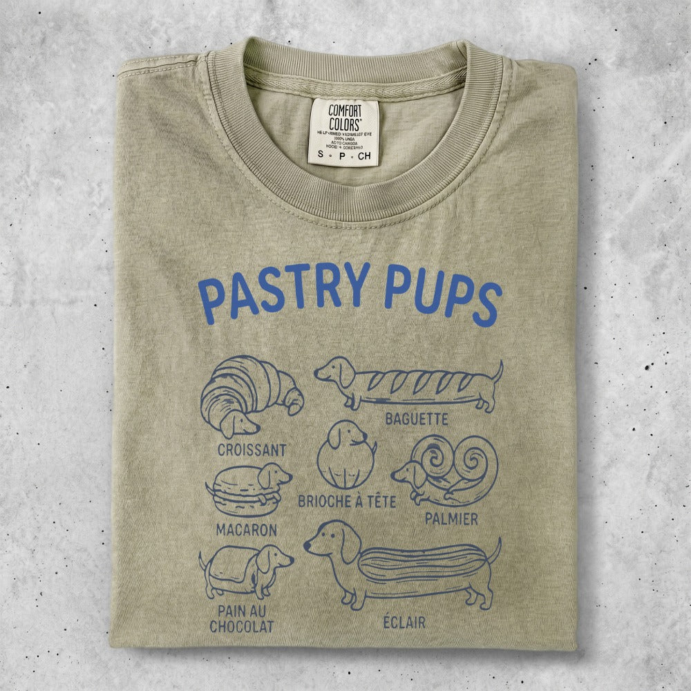 T-shirt with "Pastry Pups" text and illustrations of dogs as pastries.