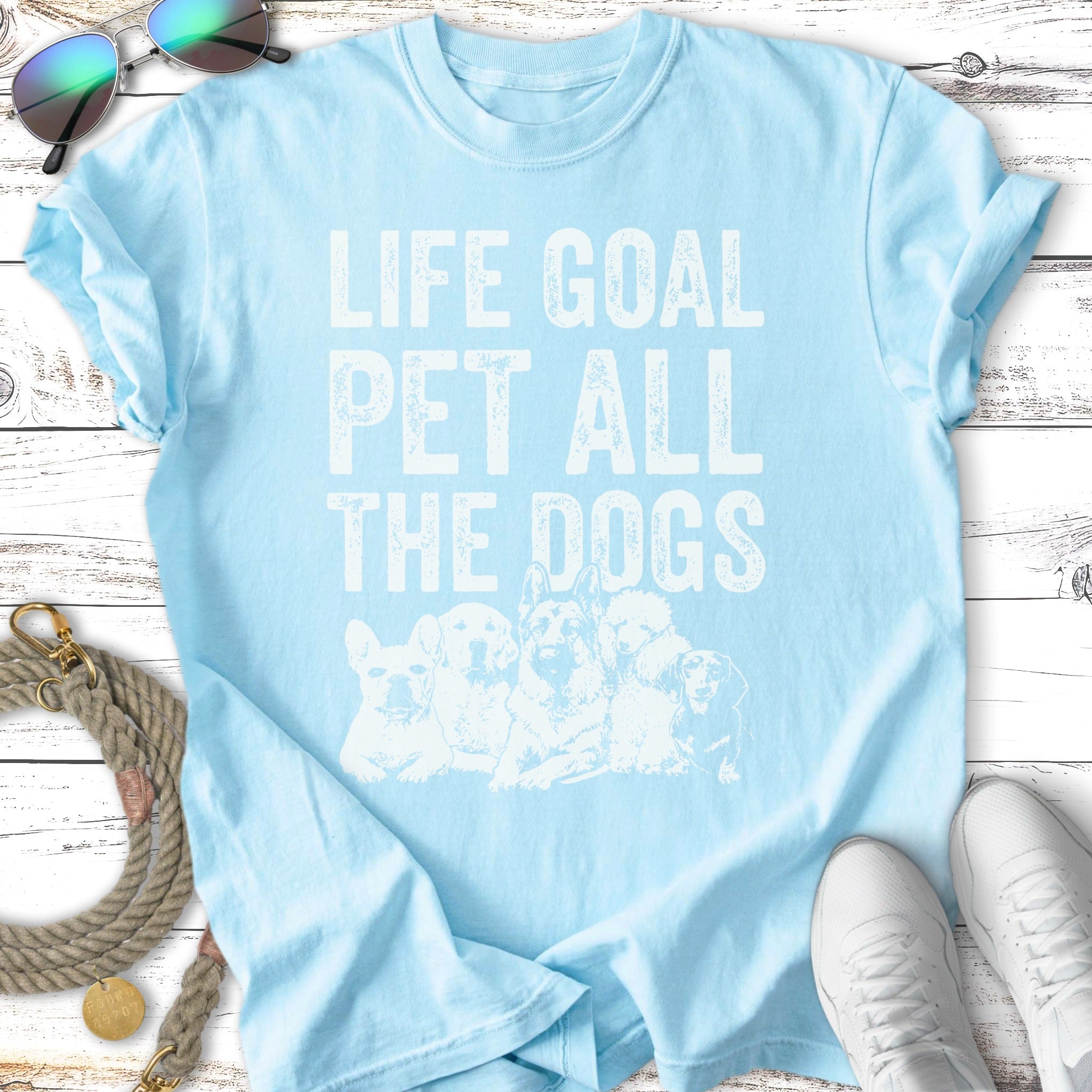 Light blue t-shirt with "LIFE GOAL PET ALL THE DOGS" and dog illustrations.