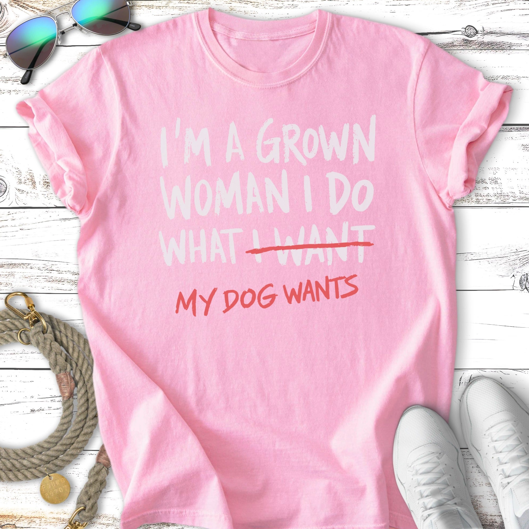 Pink t-shirt with "I'm a grown woman I do what I want my dog wants" text.