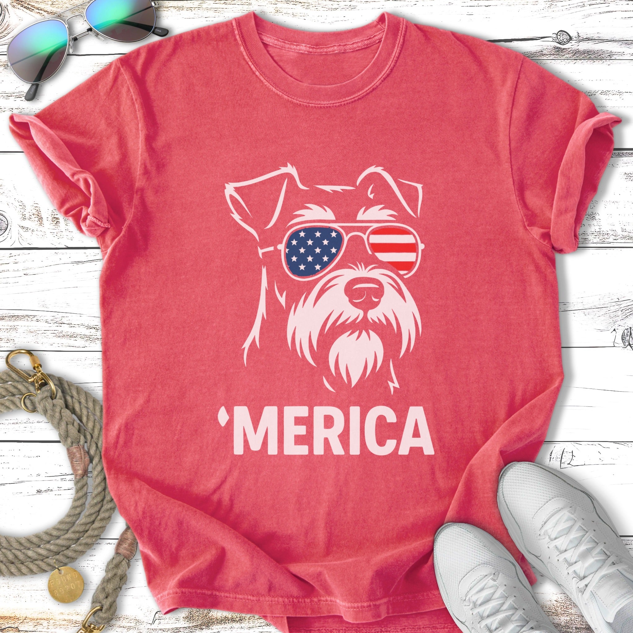 Schnauzer wearing sunglasses with American flag and "Merica" text.