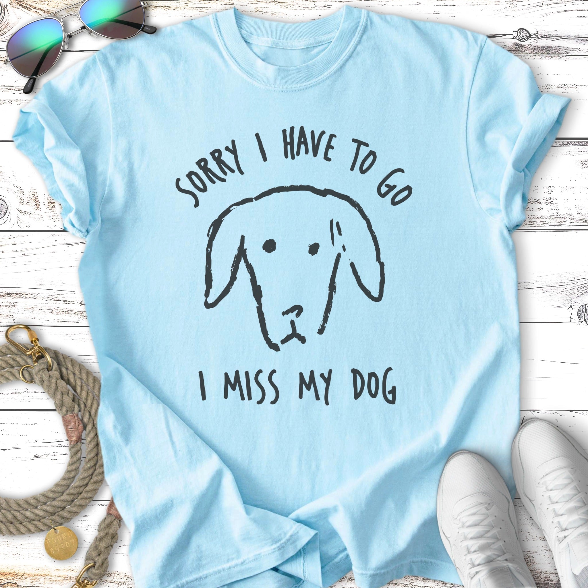Light blue t-shirt with a sketch of a dog and text "SORRY I HAVE TO GO I MISS MY DOG".