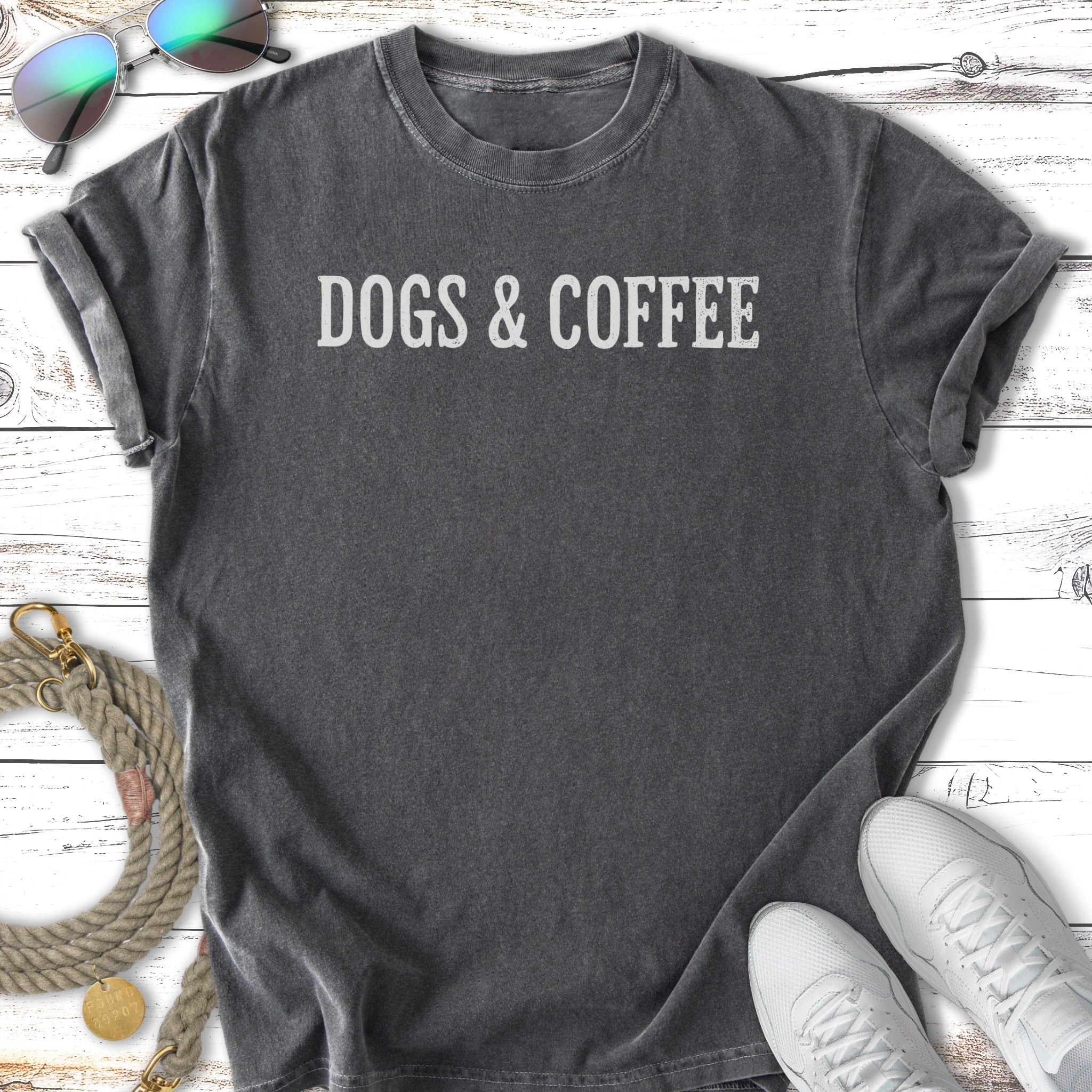 Dark gray t-shirt with white text "DOGS & COFFEE".