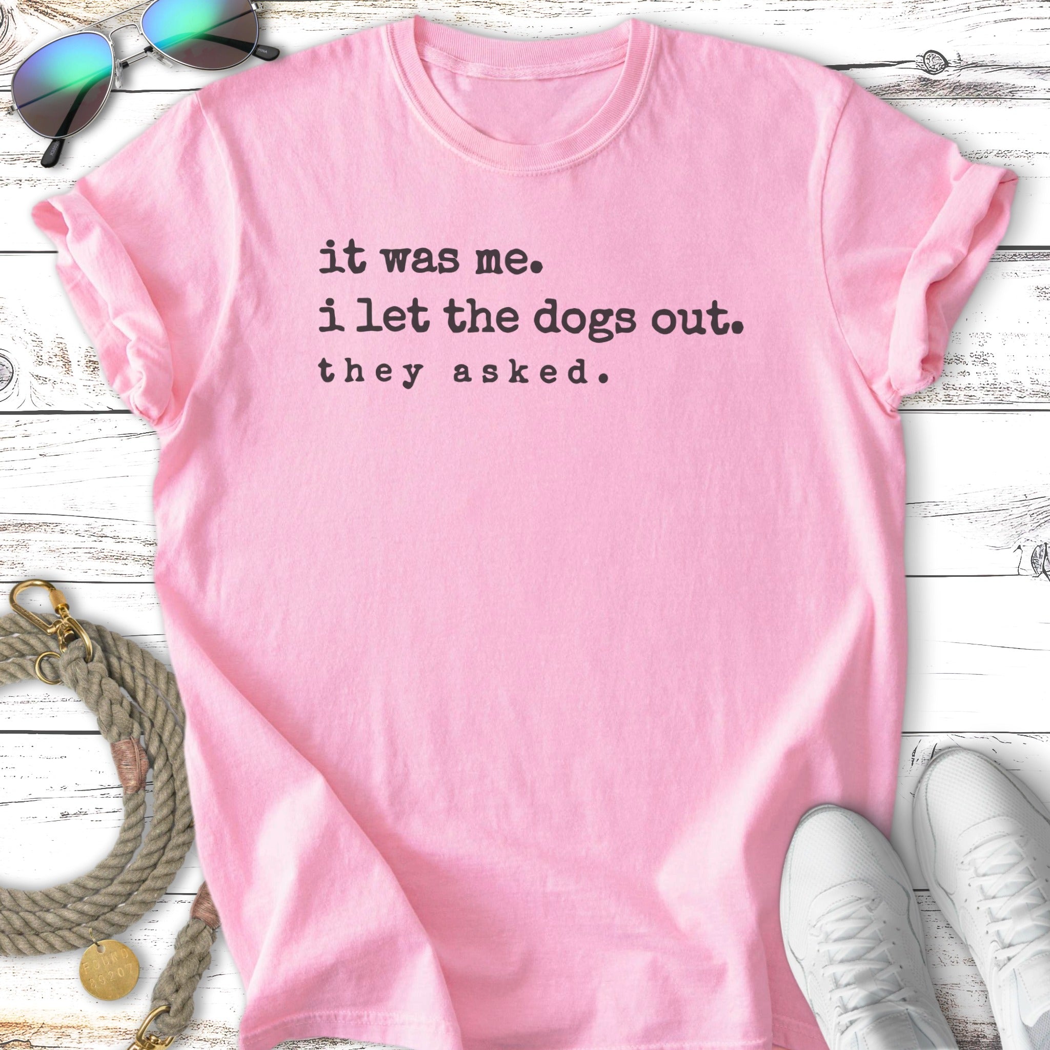 Pink t-shirt with "it was me. i let the dogs out. they asked." text.