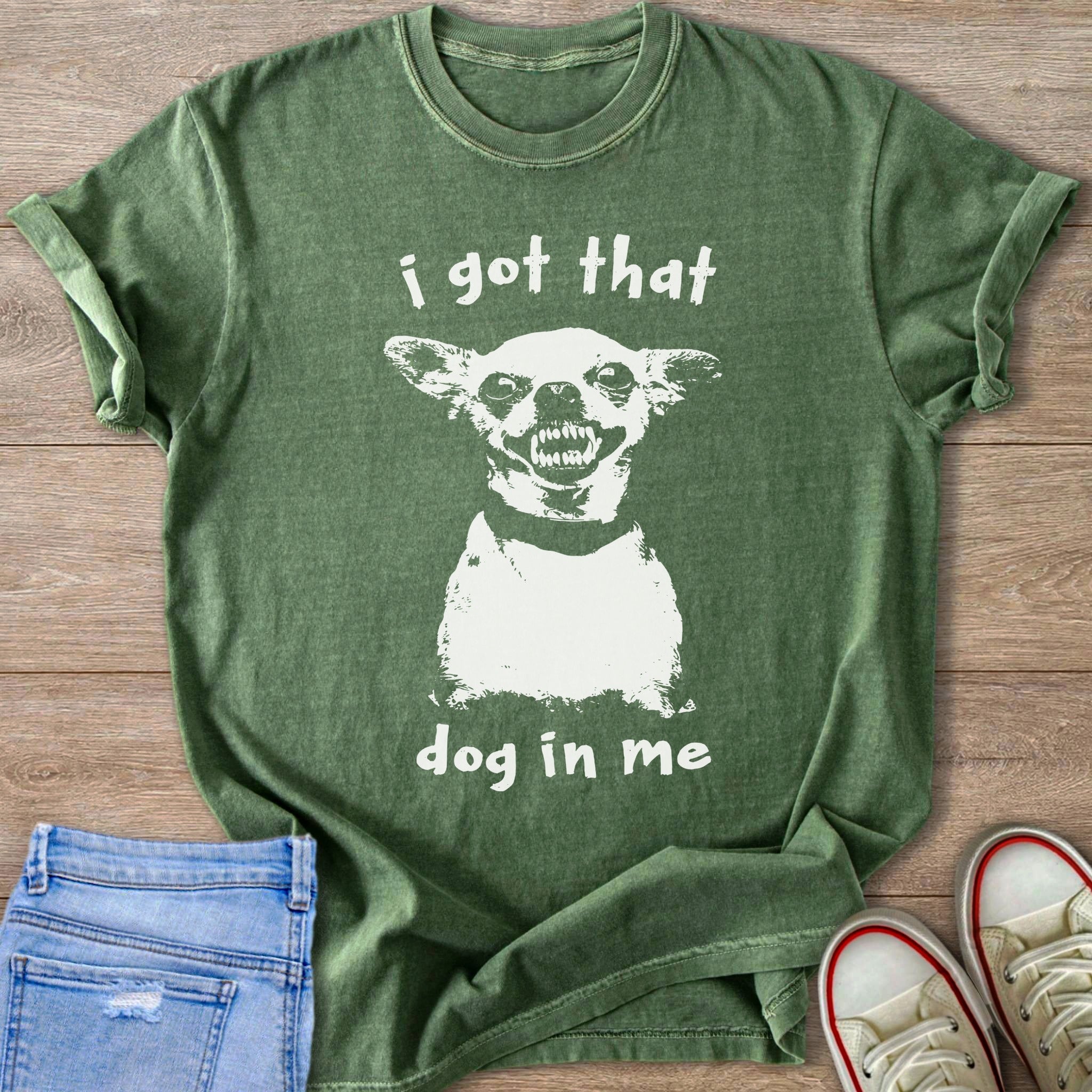 Green t-shirt with white graphic of a dog and text "i got that dog in me".