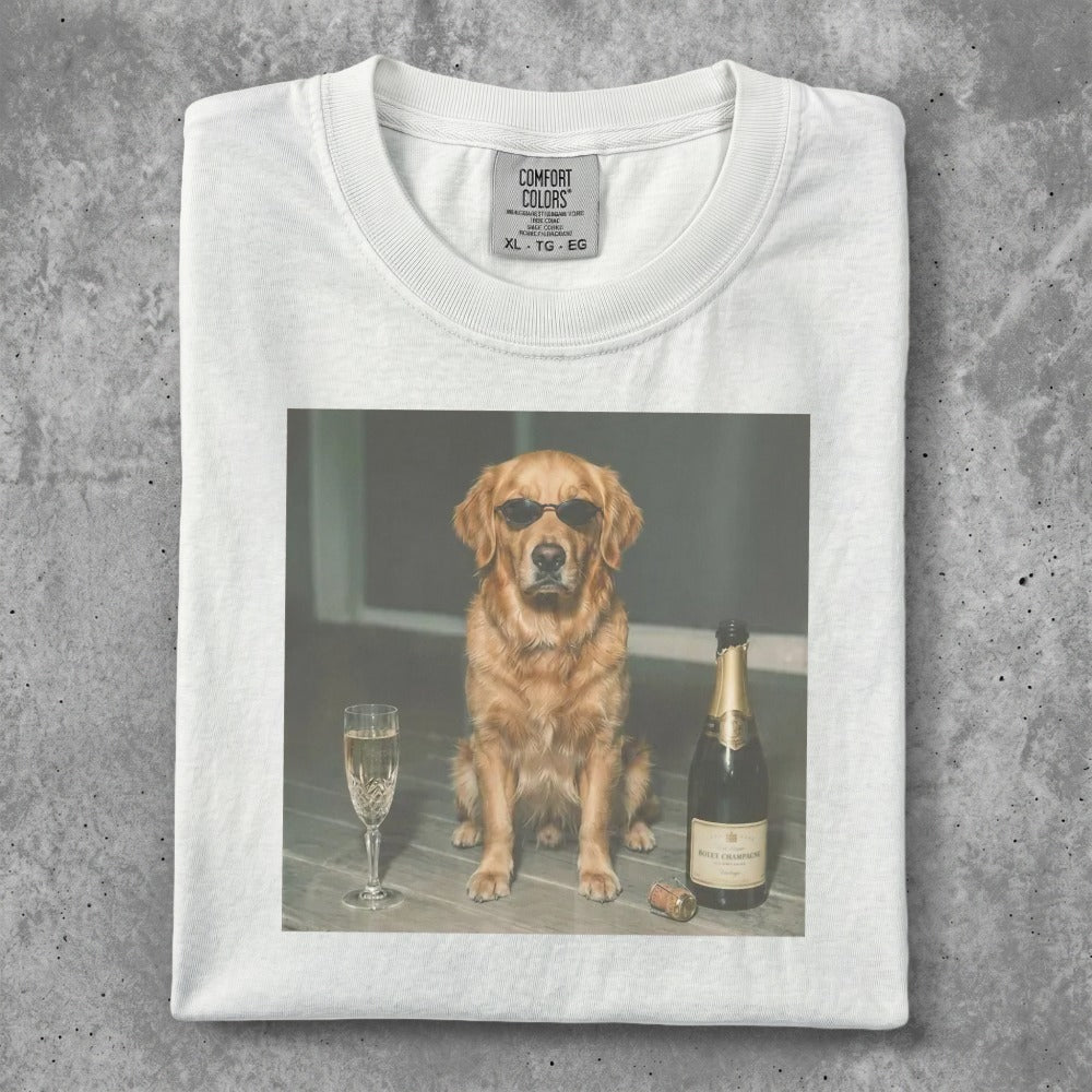 Golden retriever wearing sunglasses sits next to champagne bottle and glass.
