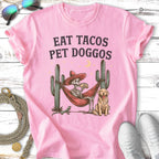 Pink t-shirt with "Eat Tacos Pet Doggos" text, skeleton in hammock with taco, dog, and cactus.
