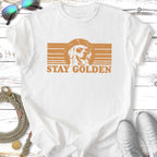 White t-shirt with golden retriever wearing sunglasses and "STAY GOLDEN" text.