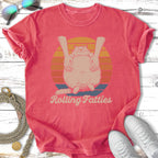 T-shirt with a cat being squeezed between hands and the text "Rolling Fatties".