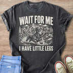 Dachshund dog with text "WAIT FOR ME I HAVE LITTLE LEGS" on a dark t-shirt.