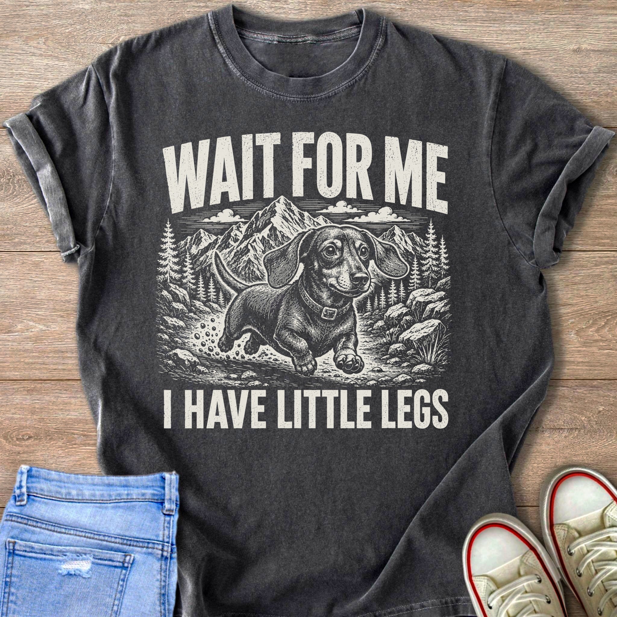Dachshund dog with text "WAIT FOR ME I HAVE LITTLE LEGS" on a dark t-shirt.