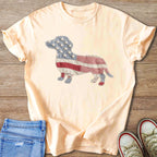 Peach t-shirt with a dachshund silhouette made of American flag patchwork.
