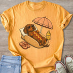 Dachshund in a hot dog bun wearing sunglasses with sunscreen and umbrella.