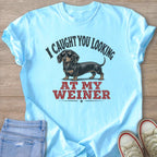 Light blue t-shirt with a dachshund wearing sunglasses and text "I CAUGHT YOU LOOKING AT MY WEINER".