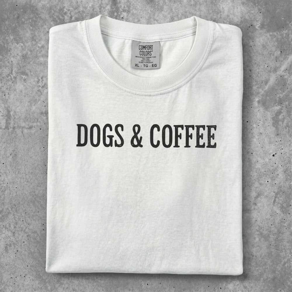 White t-shirt with "DOGS & COFFEE" text printed in black.