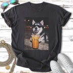 Husky wearing sunglasses holds iced coffee on a dark street.