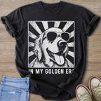 Black t-shirt with sunglasses-wearing golden retriever graphic and text "IN MY GOLDEN ER".