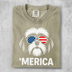 White Shih Tzu wearing American flag sunglasses with "MERICA" text.
