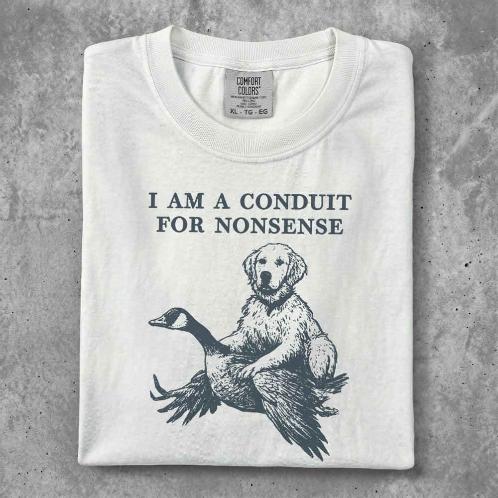 White t-shirt with a golden retriever sitting on a goose, text reads "I AM A CONDUIT FOR NONSENSE".