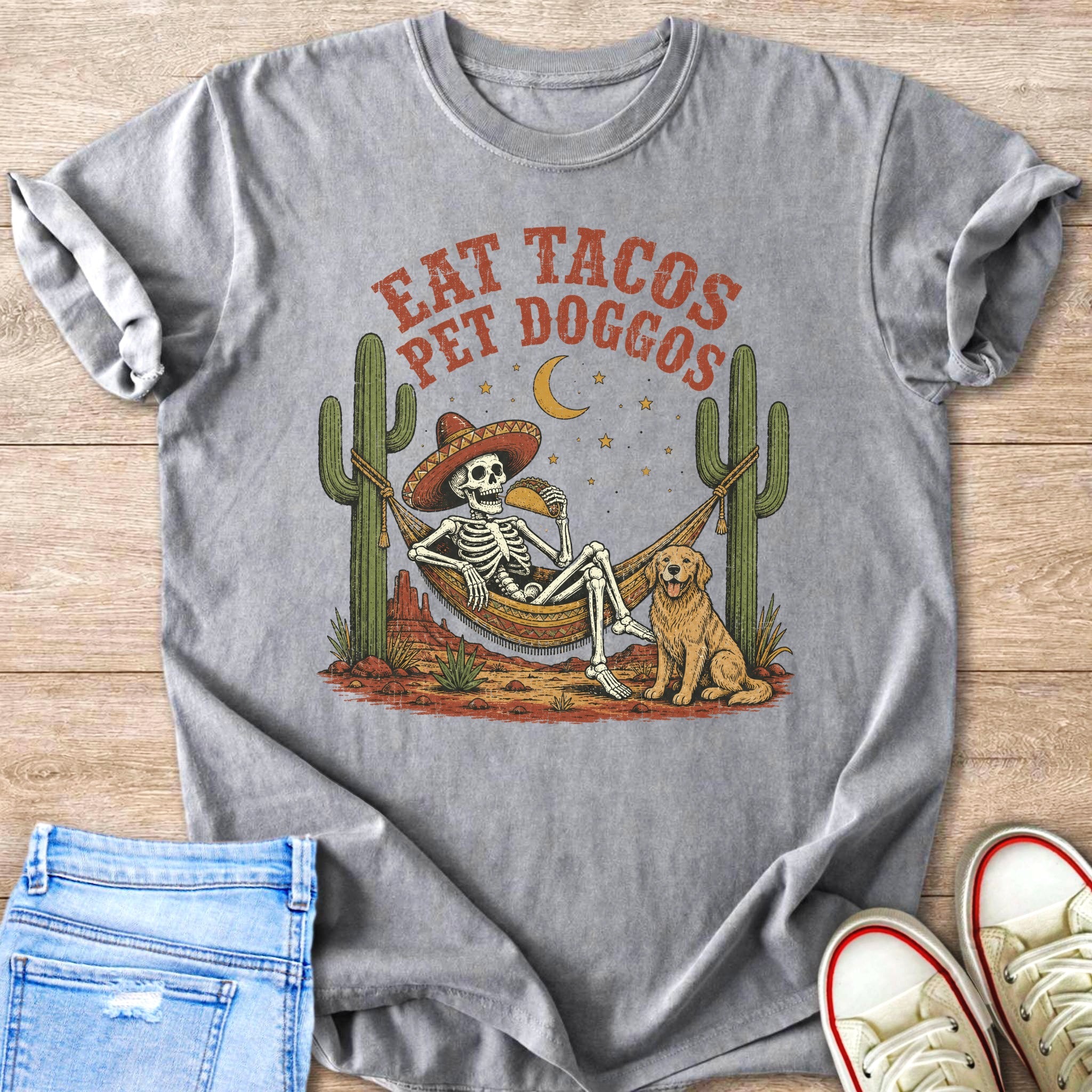 Skeleton in hammock eating taco with dog, saying "Eat Tacos Pet Doggos."