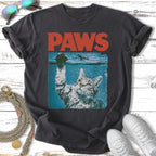 Cat reaching out of water with "PAWS" text above.
