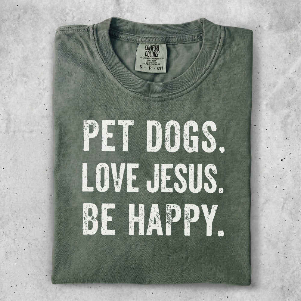 Green t-shirt with white text: PET DOGS. LOVE JESUS. BE HAPPY.