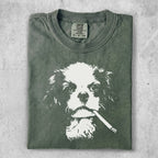 Green t-shirt with a white graphic of a dog smoking a cigarette.