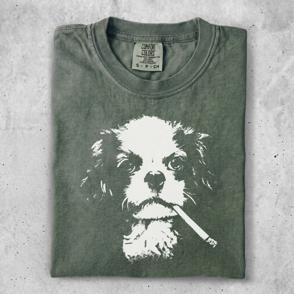 Green t-shirt with a white graphic of a dog smoking a cigarette.