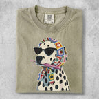 Dalmatian wearing sunglasses and a colorful crochet scarf, holding crochet hook.