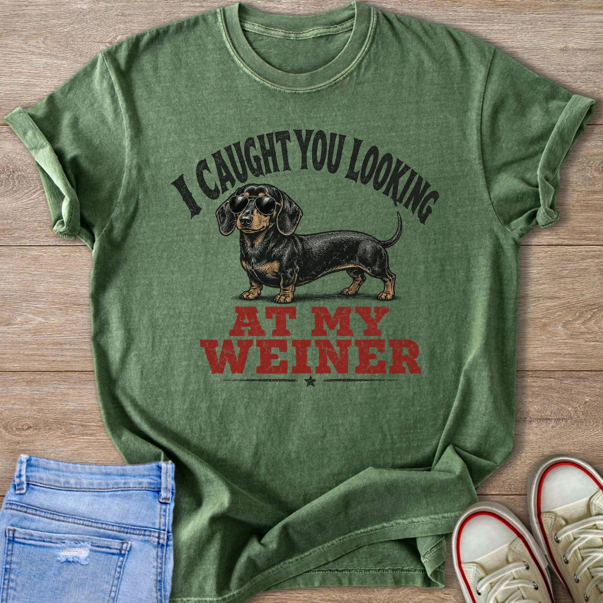 Green t-shirt with dachshund wearing sunglasses and text "I CAUGHT YOU LOOKING AT MY WEINER".