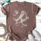 T-shirt with distressed graphic of a Pomeranian on a cliff under a moonlit sky.