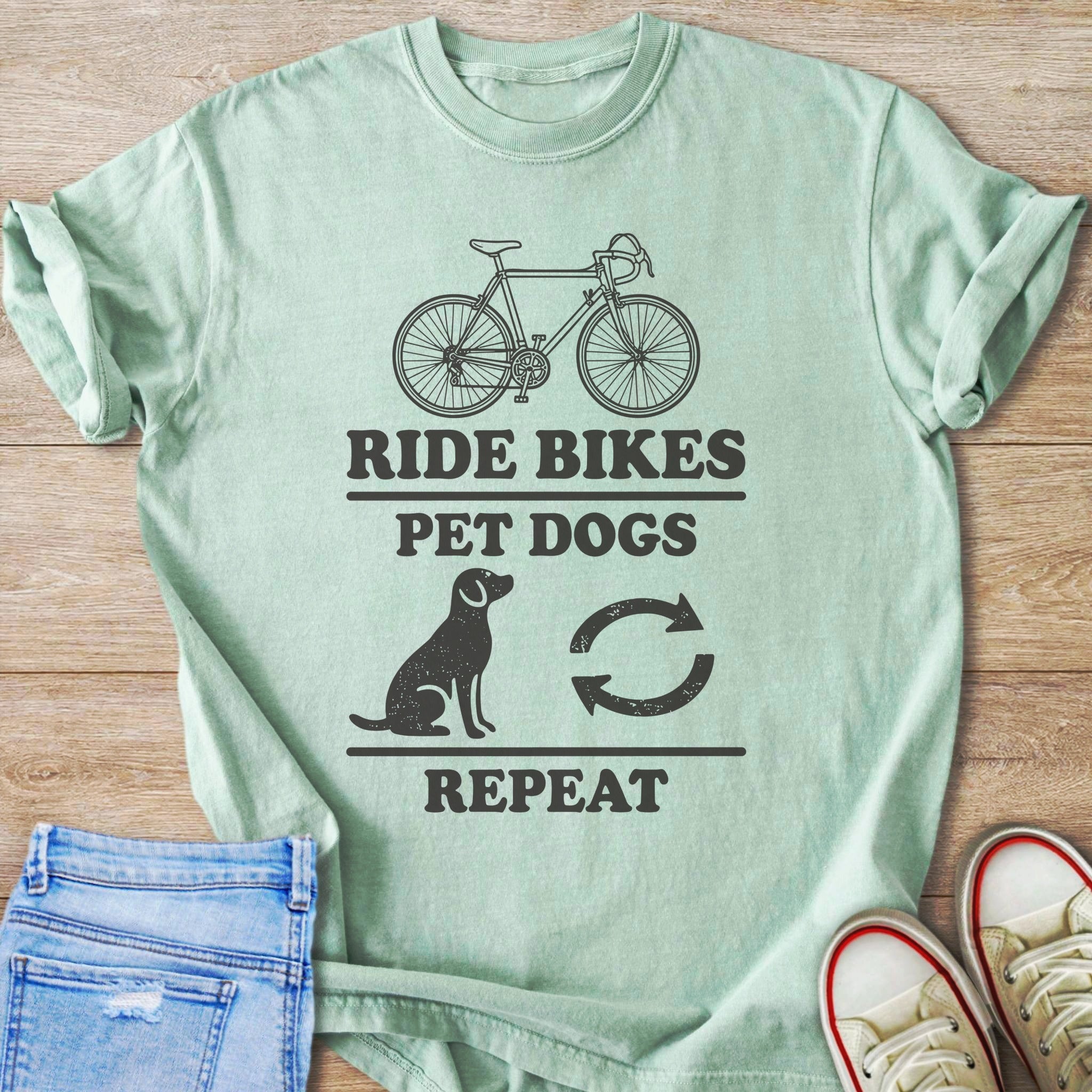 Light green t-shirt with "Ride Bikes Pet Dogs Repeat" text and graphics.