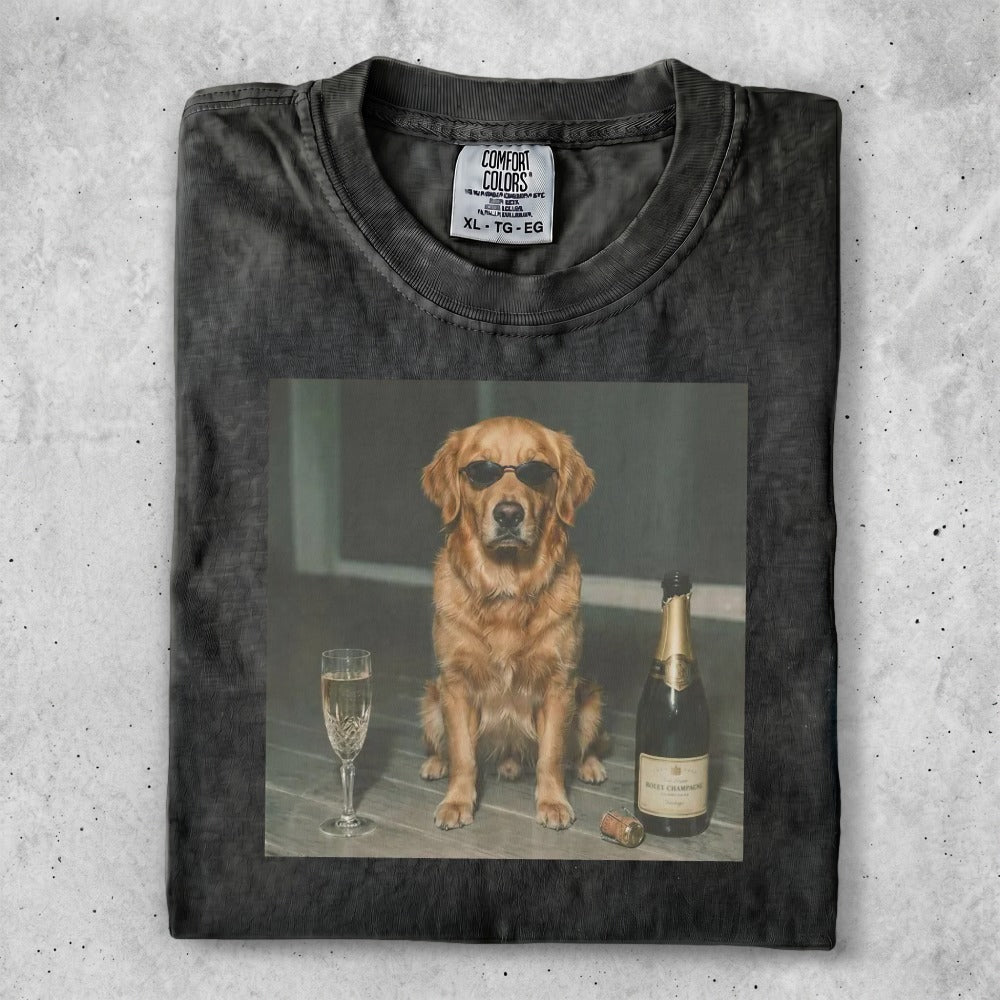 Dog wearing sunglasses sitting next to champagne bottle and glass.