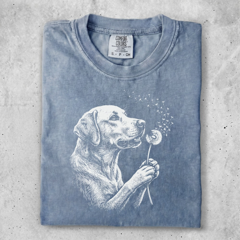 T-shirt with a white outline drawing of a dog holding a dandelion.