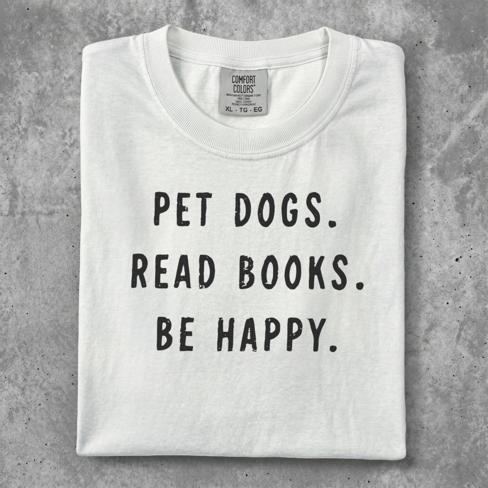 White t-shirt with "Pet dogs. Read books. Be happy." text.