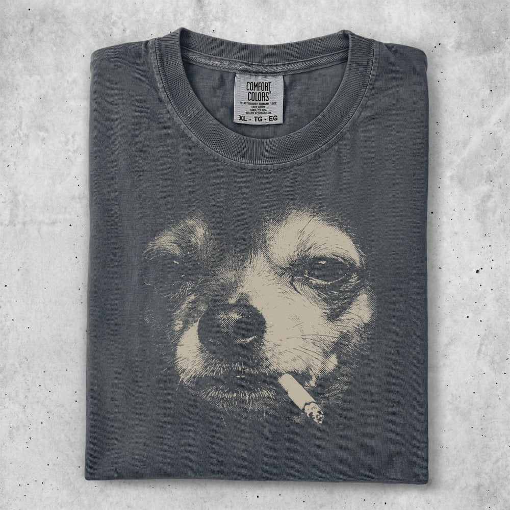 Dark t-shirt featuring a charcoal sketch of a dog's face with a cigarette.