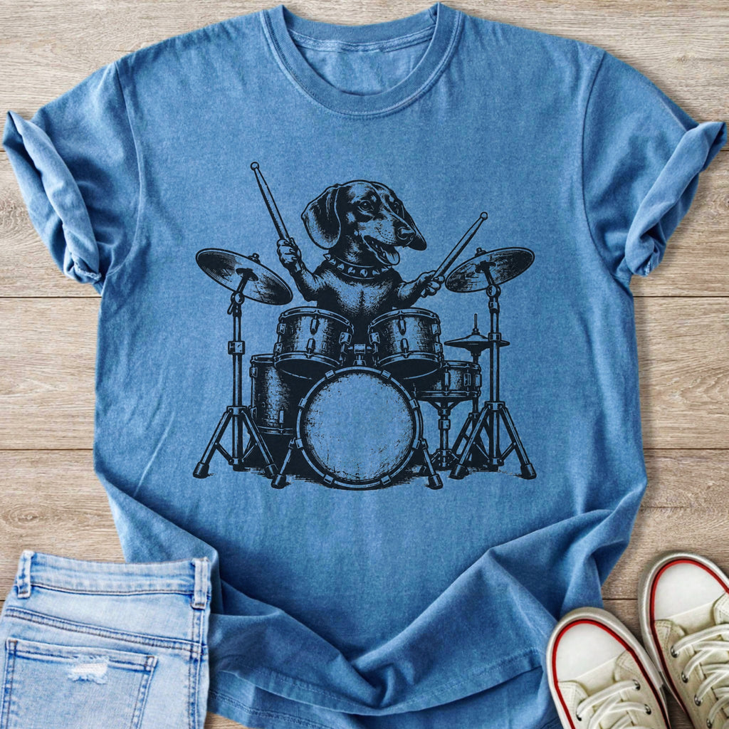 Dachshund playing a drum set with drumsticks in a black graphic on a blue t-shirt.