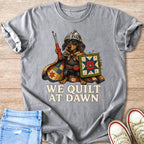 Dachshund wearing a knight's helmet and cape, holding sewing tools and a quilt.