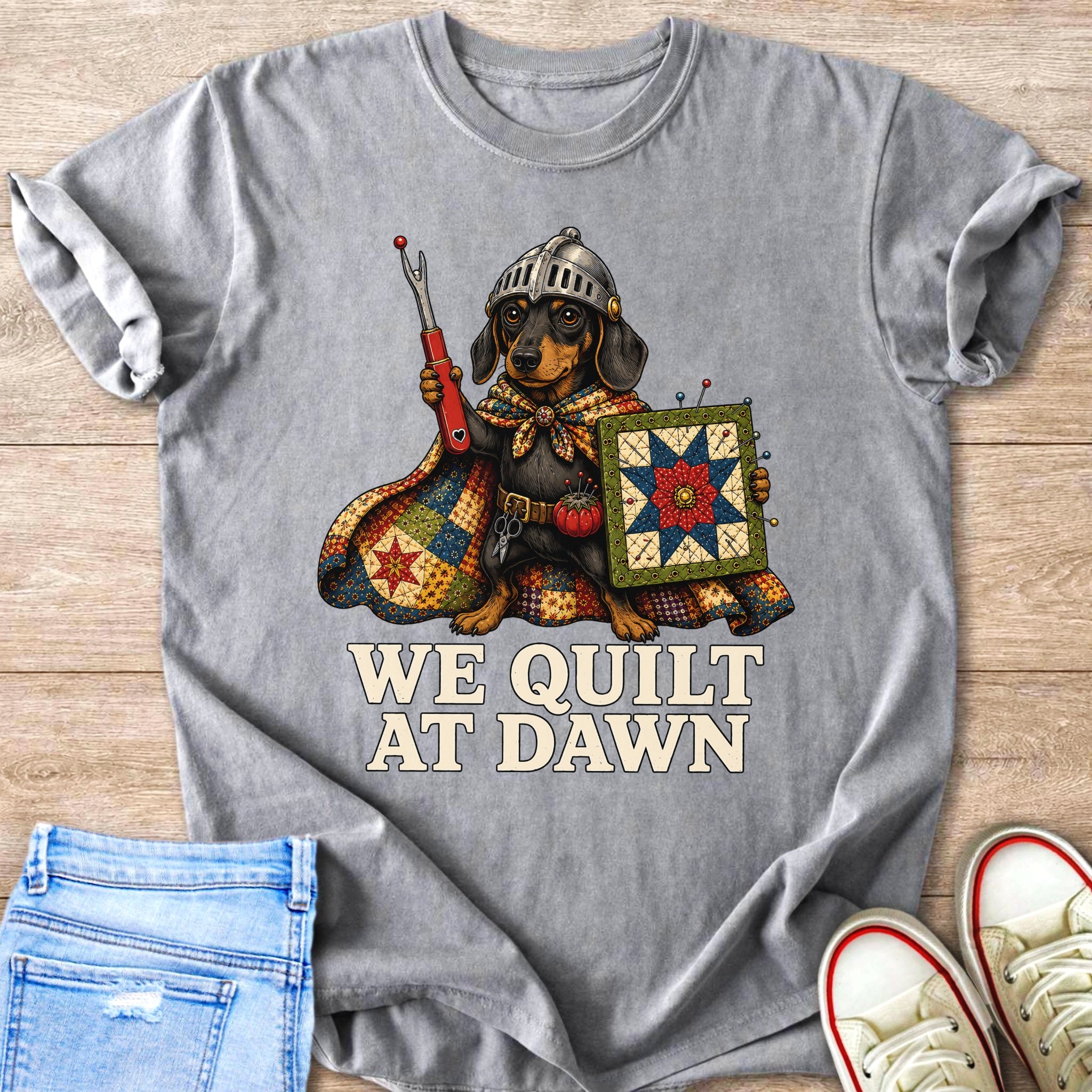 Dachshund wearing a knight's helmet and cape, holding sewing tools and a quilt.