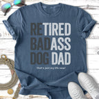 Navy t-shirt with "RETIRED BADASS DOG DAD" and "that's just my life now!"