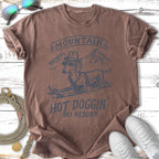 T-shirt with a dachshund wearing sunglasses and a hat skiing, "Mountain Hot Doggin' Ski Resort" text.