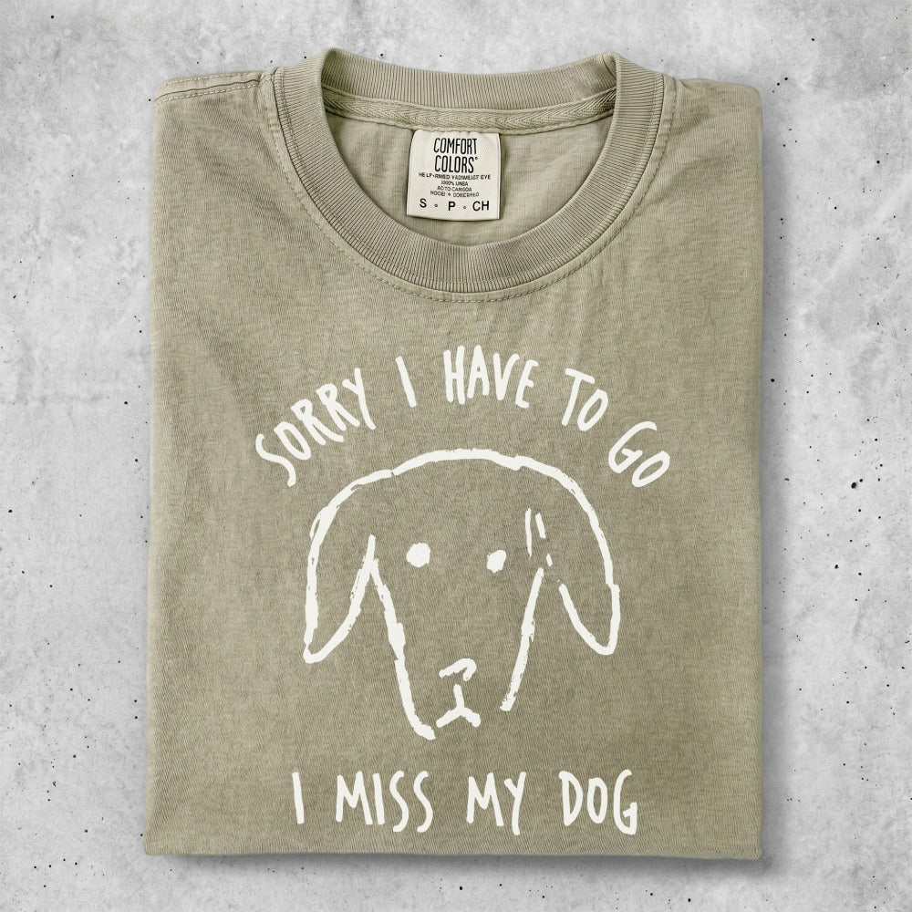 Beige t-shirt with a white dog drawing and "Sorry I have to go, I miss my dog" text.