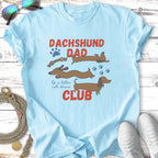 Light blue t-shirt with "Dachshund Dad Club" and dachshund illustrations.