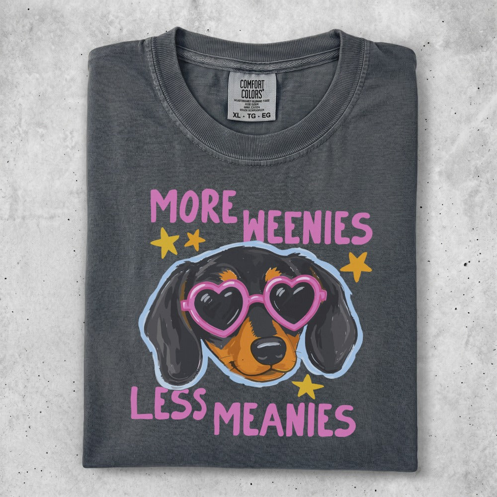 T-shirt with dachshund wearing heart sunglasses and "More Weenies Less Meanies" text.