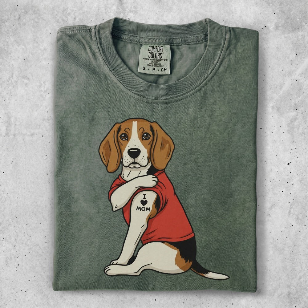 Beagle wearing a red shirt with an "I love Mom" tattoo on its arm.