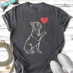 French bulldog holding a red balloon in its paw.