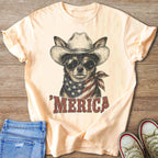 T-shirt graphic of a dog wearing a cowboy hat, sunglasses, and an American flag bandana with "MERICA" text.