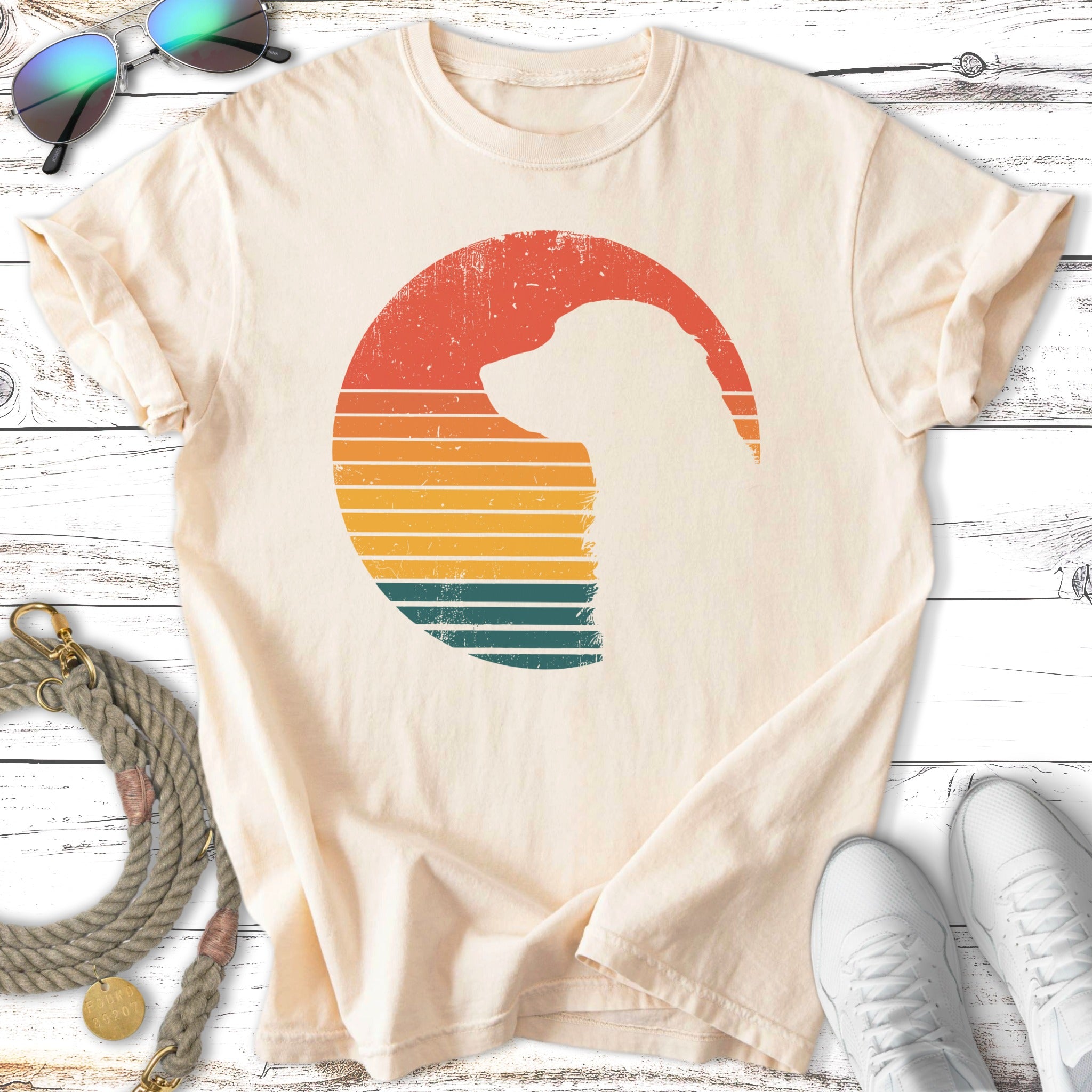 Cream t-shirt with dog silhouette and retro sunset stripes.
