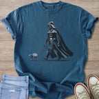 Darth Vader walking a small AT-ST walker on a leash on a blue t-shirt.
