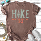 T-shirt with "HIKE AND PET ALL THE DOGS" text and a pine tree graphic.